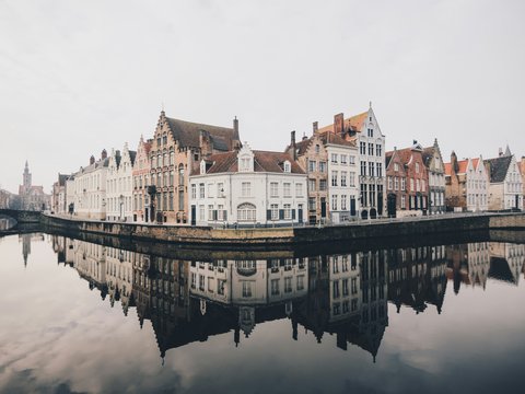 white and brown concrete buildings near bodies of water