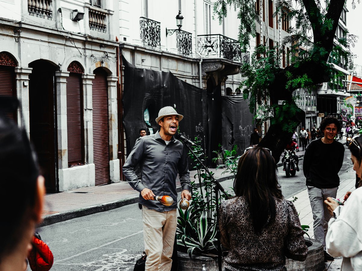 A group of people standing on the side of a street