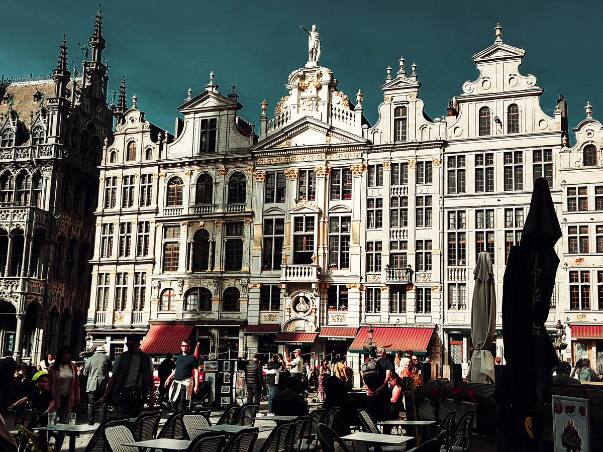 a group of people standing in front of a large building