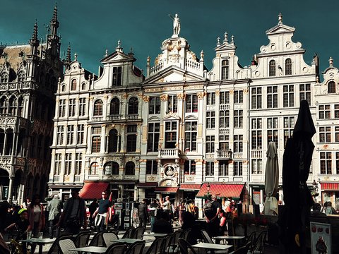 a group of people standing in front of a large building