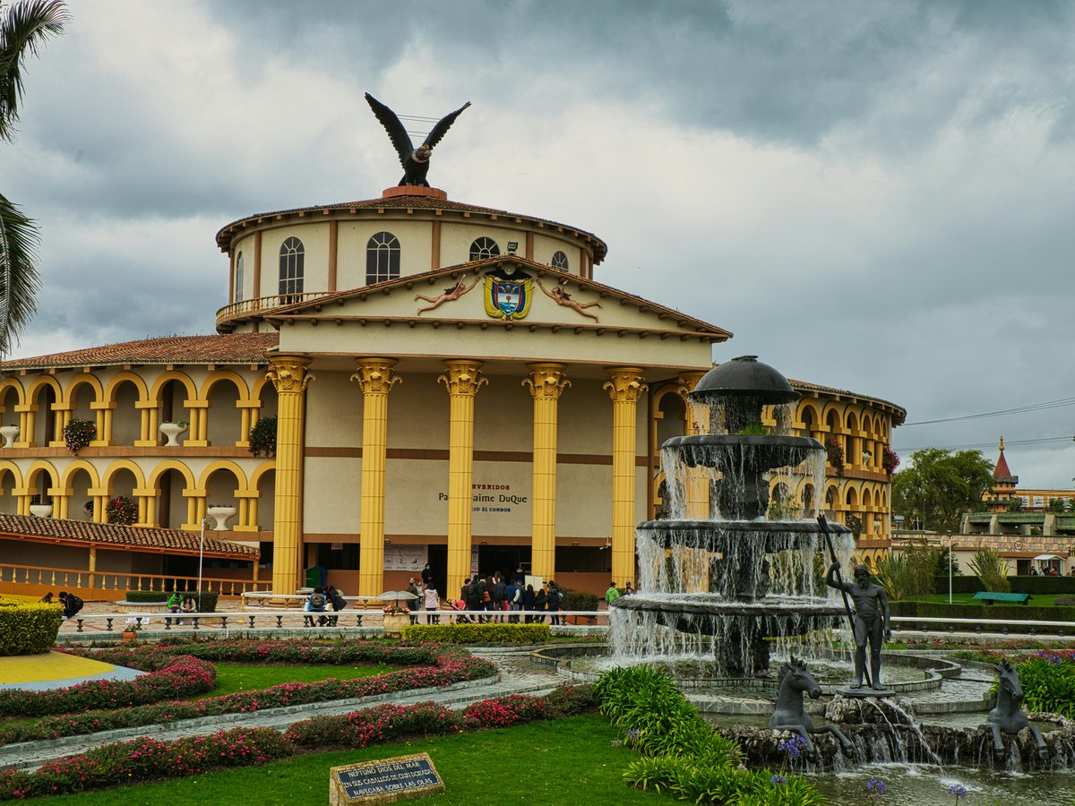 a large building with a fountain in front of it
