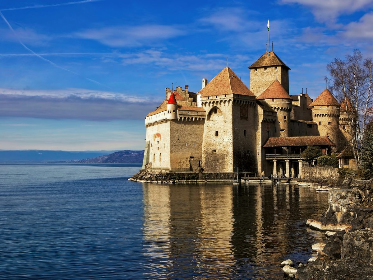 castle by the sea under blue sky