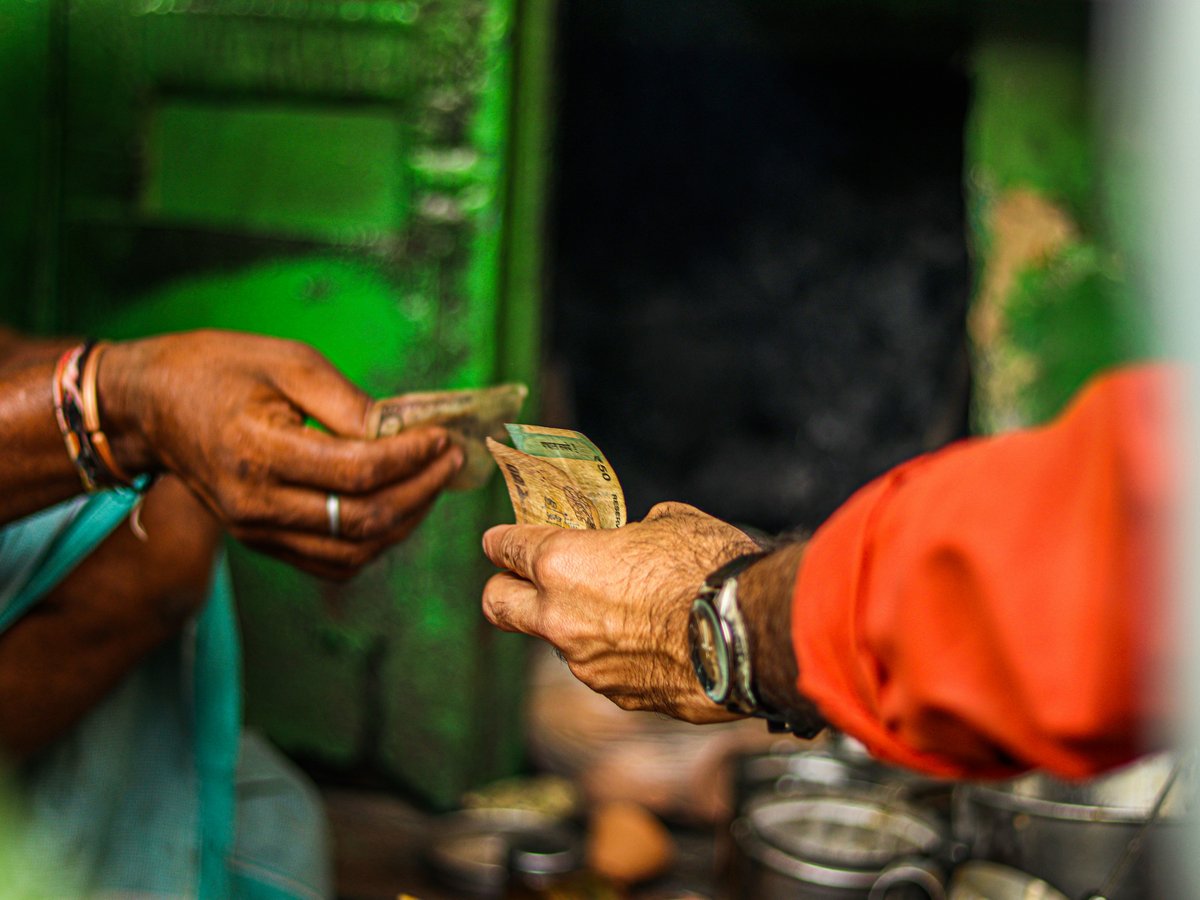 a person handing money to another person
