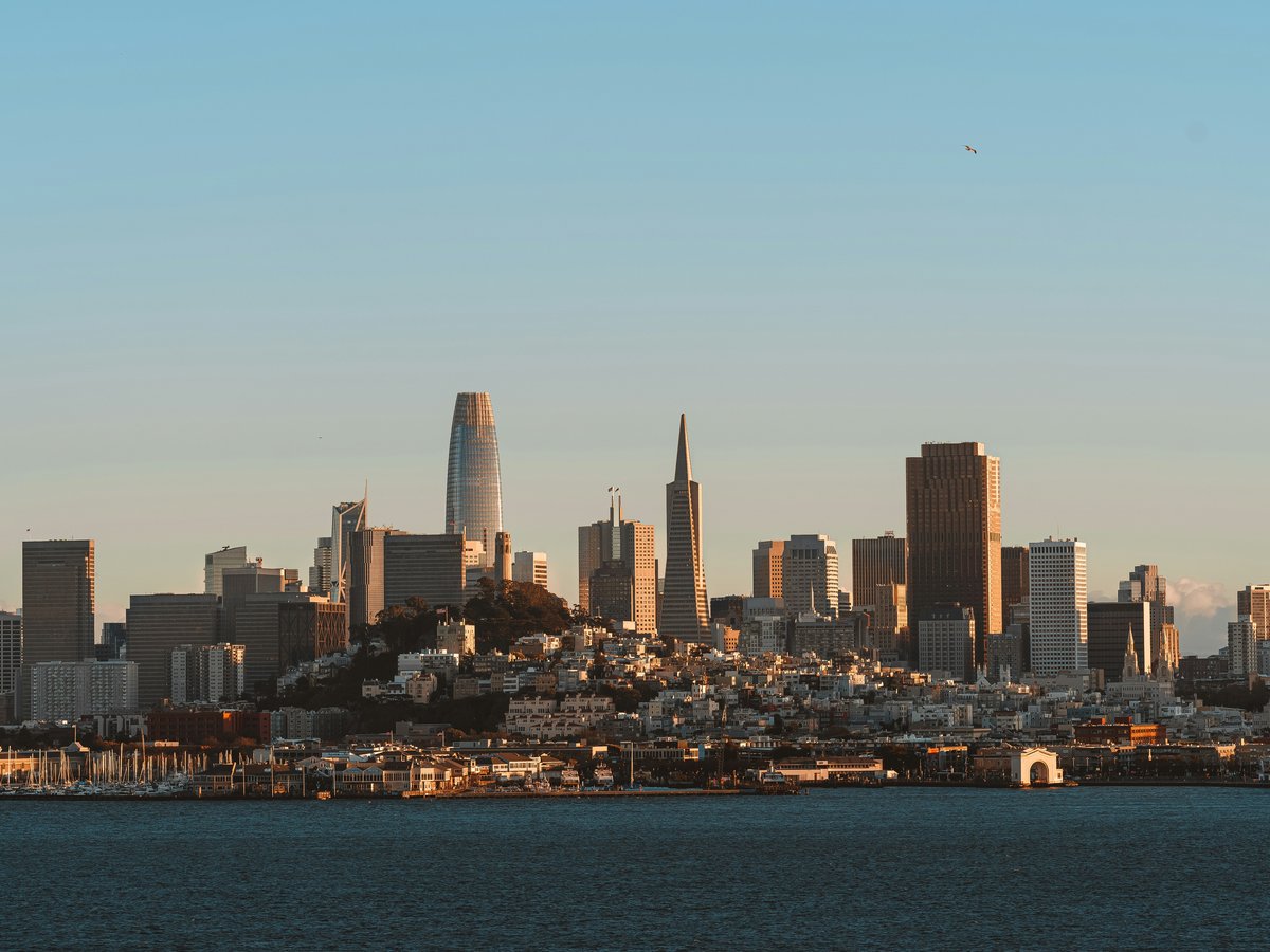 a city skyline with a body of water in the foreground