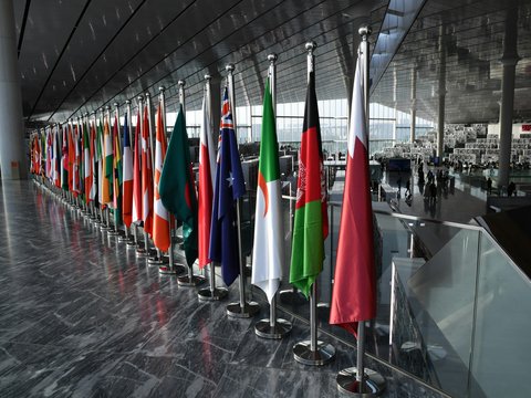 Row of national flags displayed indoors