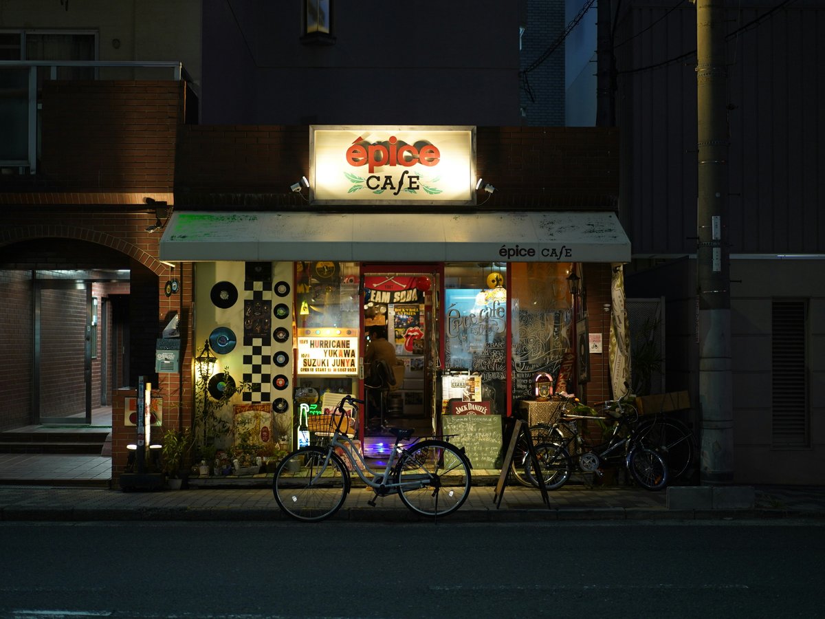 A bike parked outside of a store at night