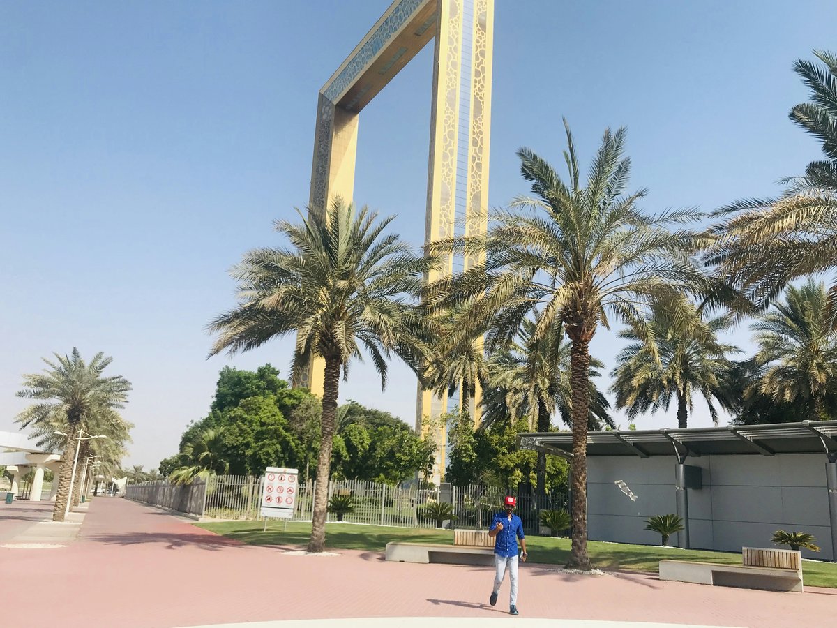 a person walking in front of a tall monument