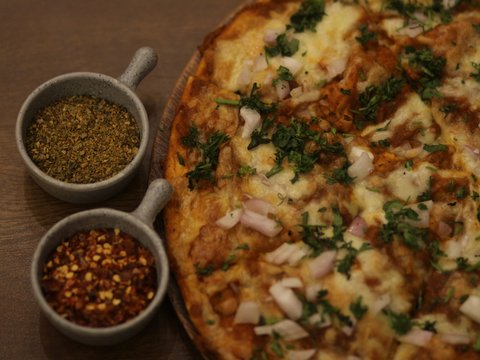 a pizza sitting on top of a wooden table