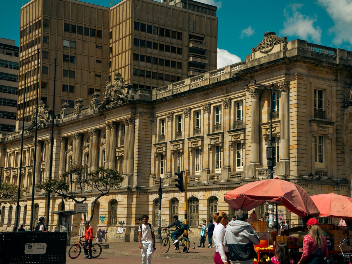 A group of people standing in front of a large building