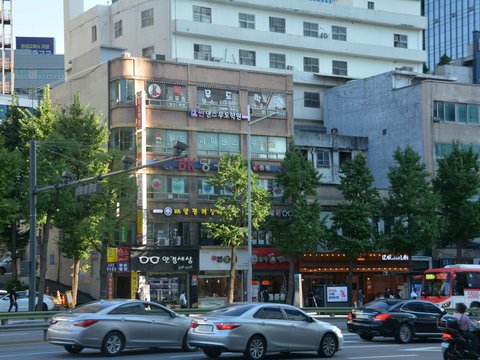 a street with cars and buildings