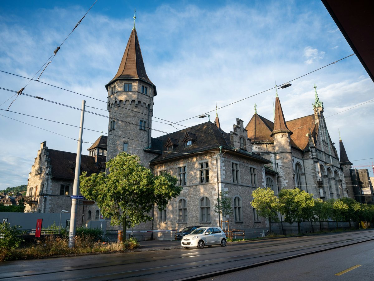 a car driving down a road next to a large building