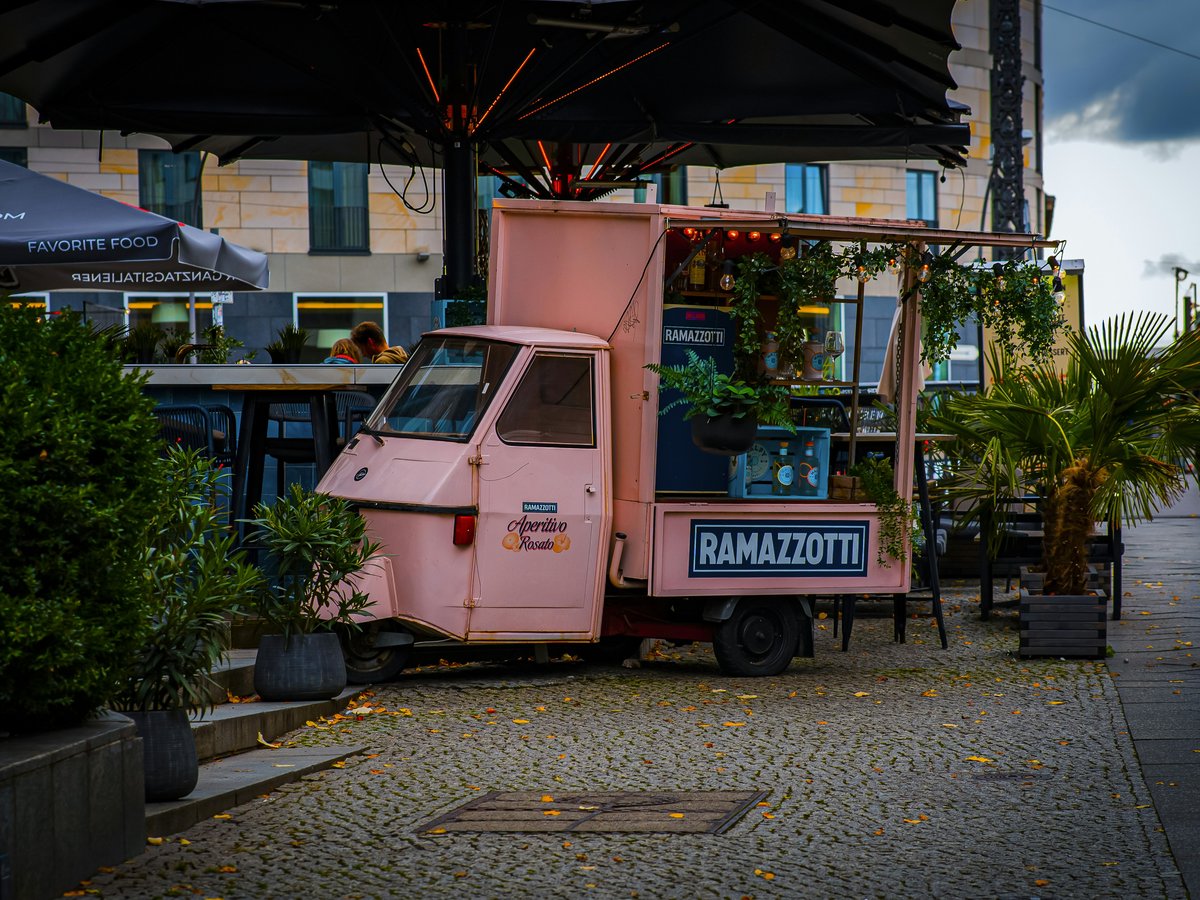 A pink truck parked on the side of a road