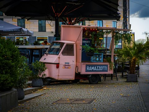 A pink truck parked on the side of a road