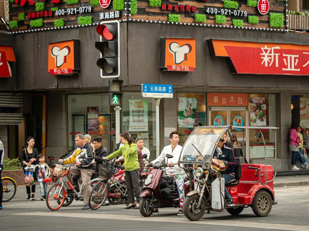 People and vehicles at a busy city intersection