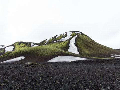 green mountain under white sky