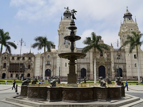 a large building with a fountain in front of it