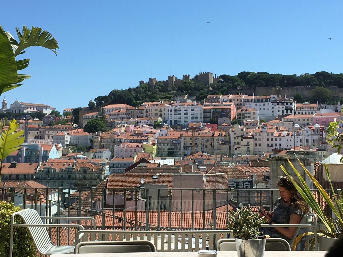 a person sitting on a balcony overlooking a city