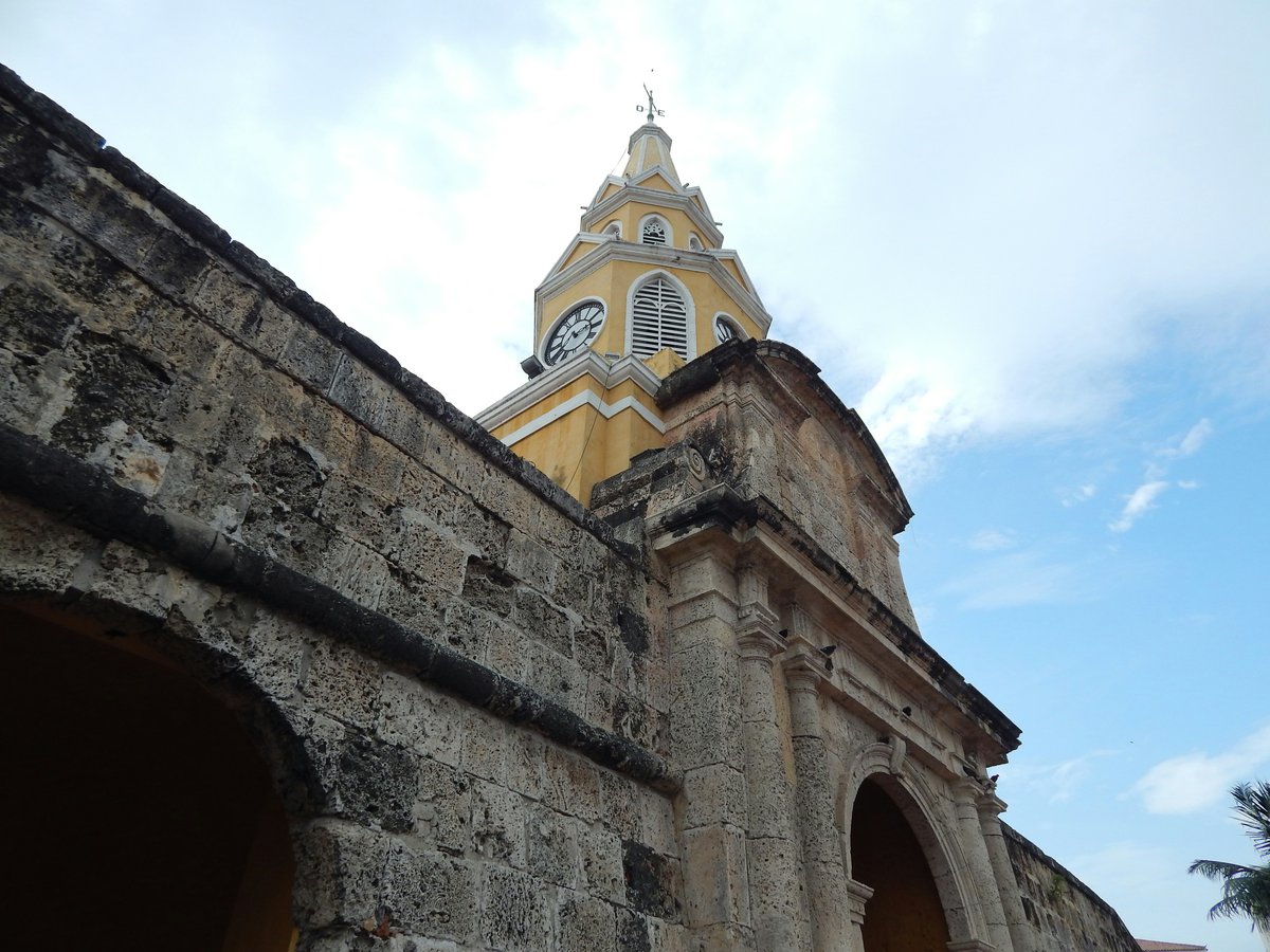 Old stone archway with clock tower above