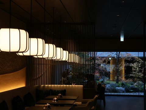 A restaurant's interior with hanging lights.