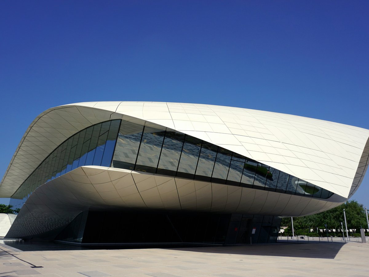 white and black concrete building under blue sky during daytime