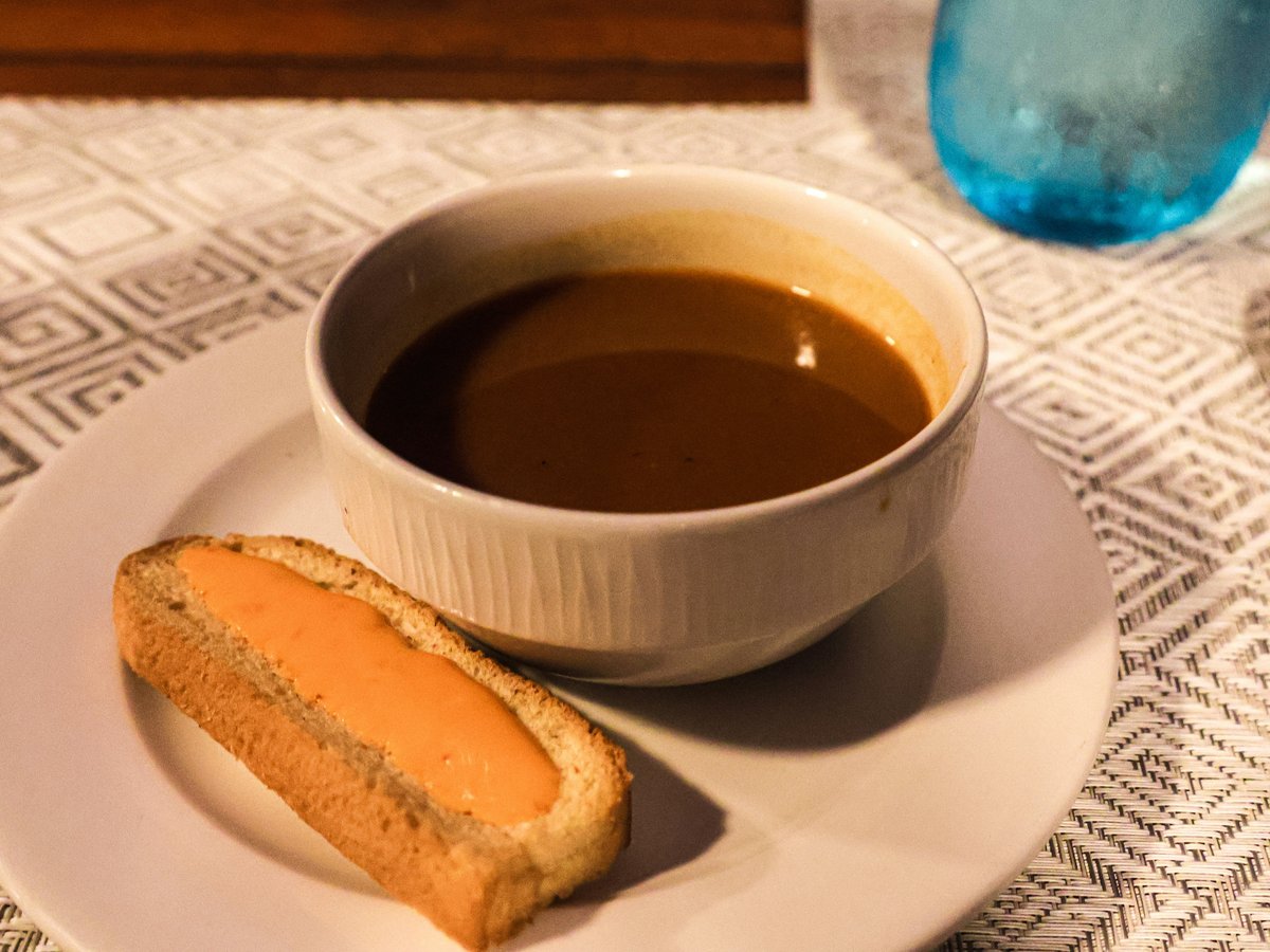 Soup and bread on a table, ready to eat