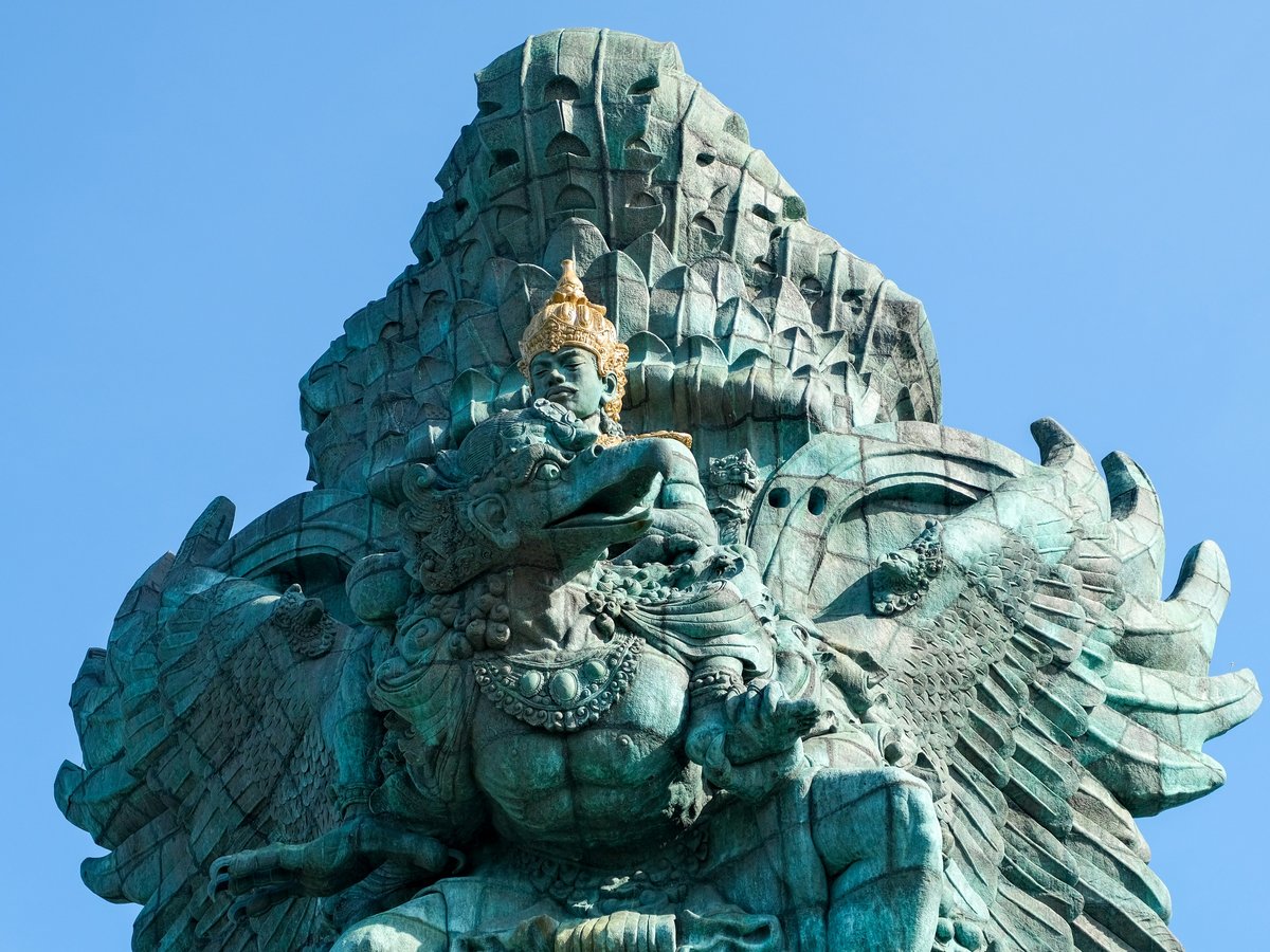 a statue of an elephant with a bird on its back
