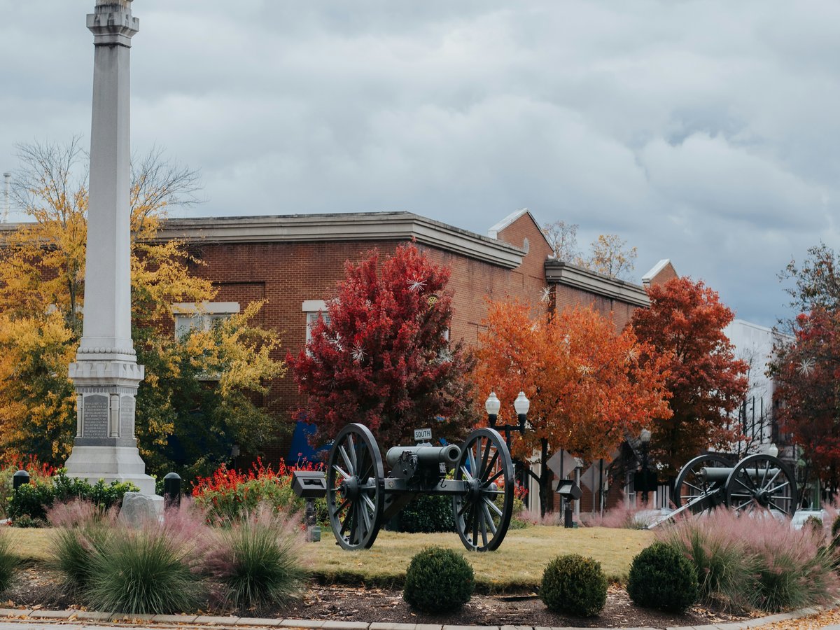 Monument and cannons in town square during autumn