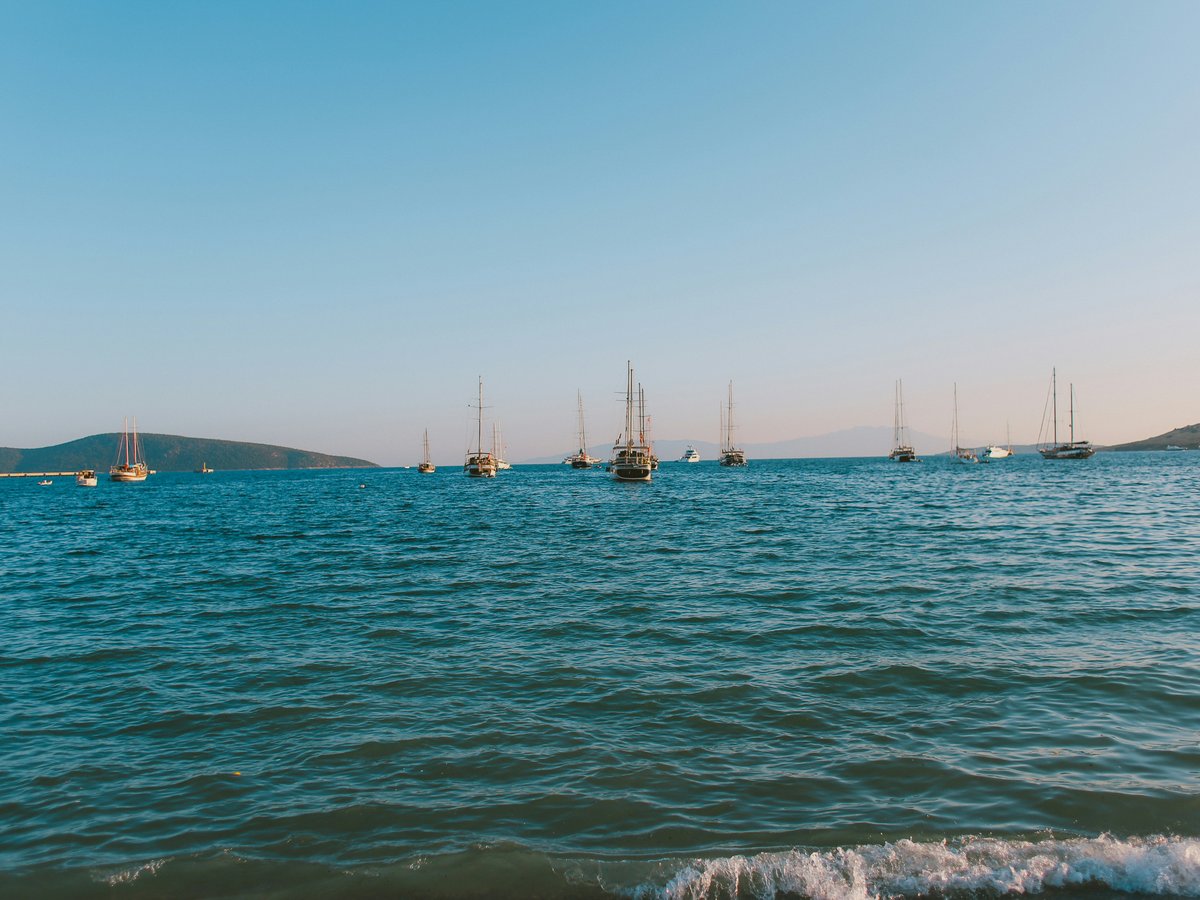 a group of boats floating on top of a large body of water