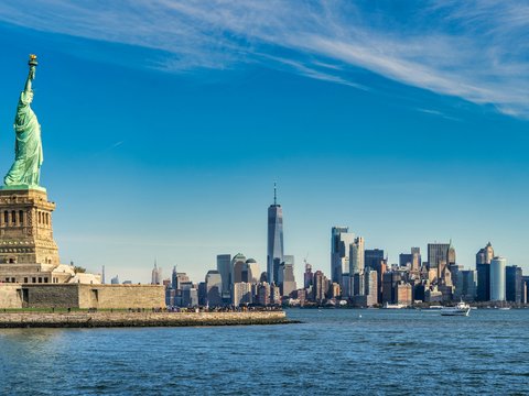 city skyline across body of water during daytime