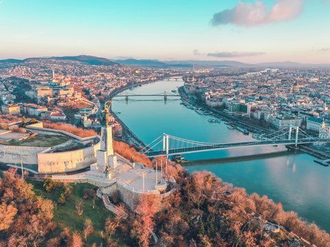aerial photography of buildings viewing bridge and sea during daytime