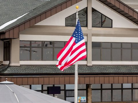 an american flag flying in front of a building