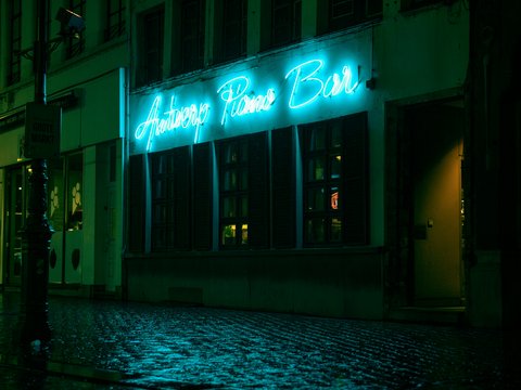a building with a neon sign on the front of it