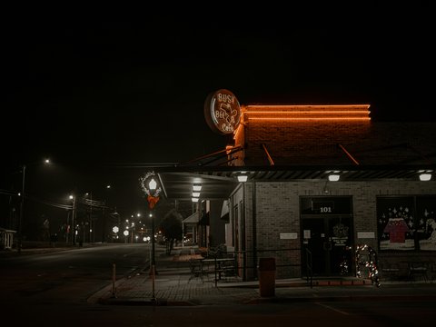 a building with a neon sign on the front of it