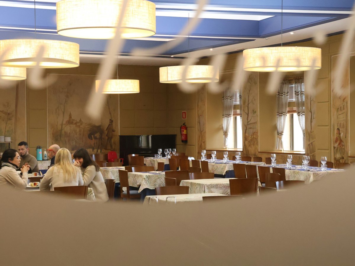 A blurry photo of people sitting at tables in a restaurant