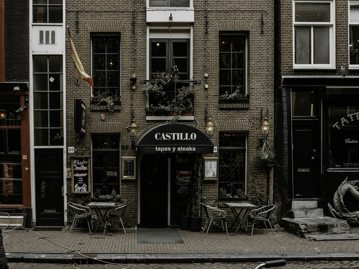 brown brick building with red and white signage