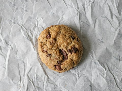 brown cookie on white textile