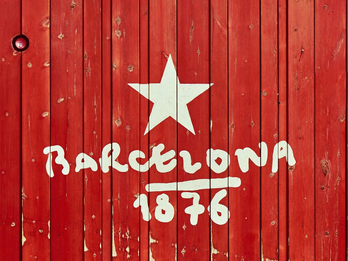 a red wooden wall with a white star painted on it