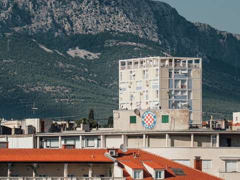Modern apartment building against a mountain backdrop