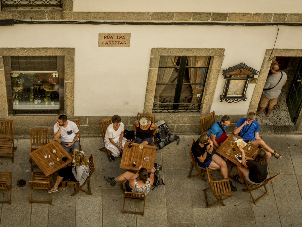 group of people sitting on brown wooden chair
