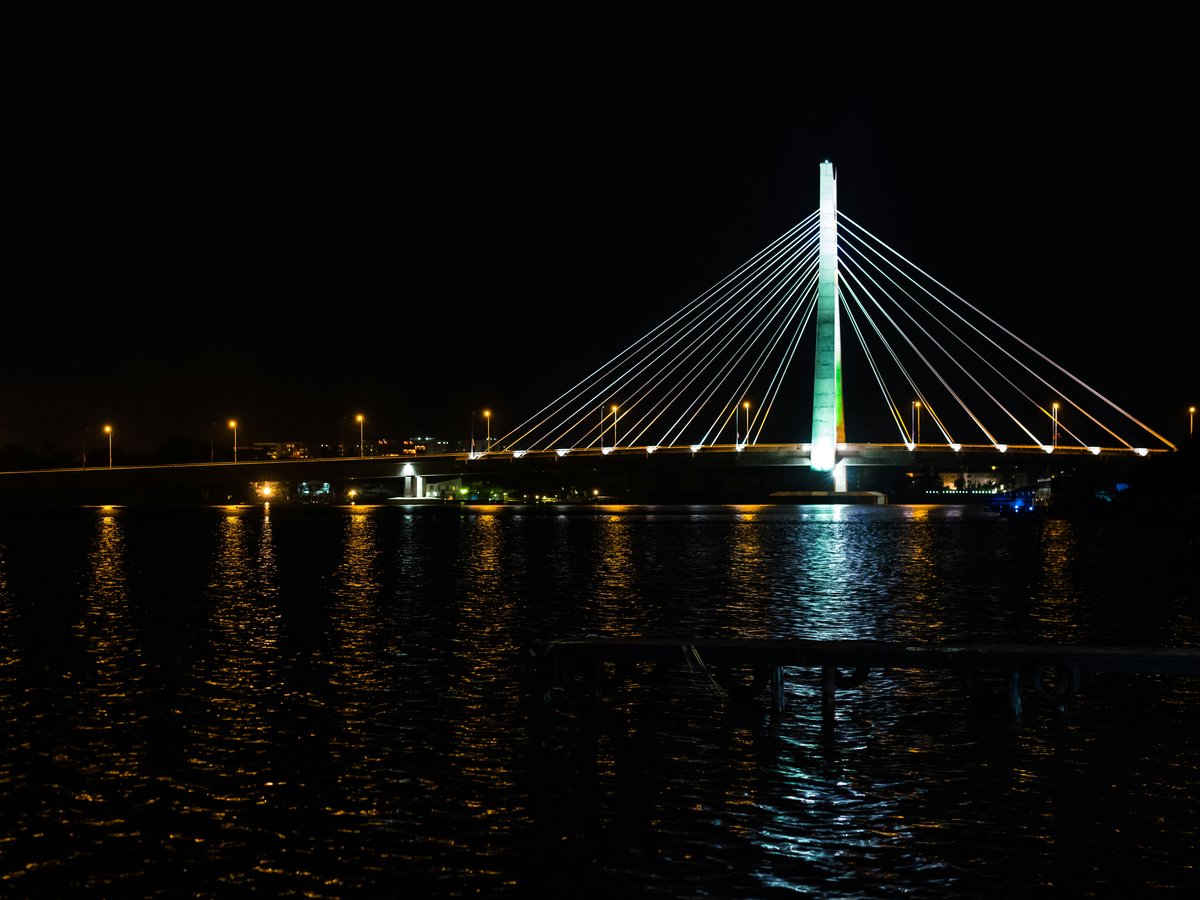 a large bridge over a body of water at night