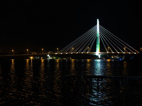 a large bridge over a body of water at night