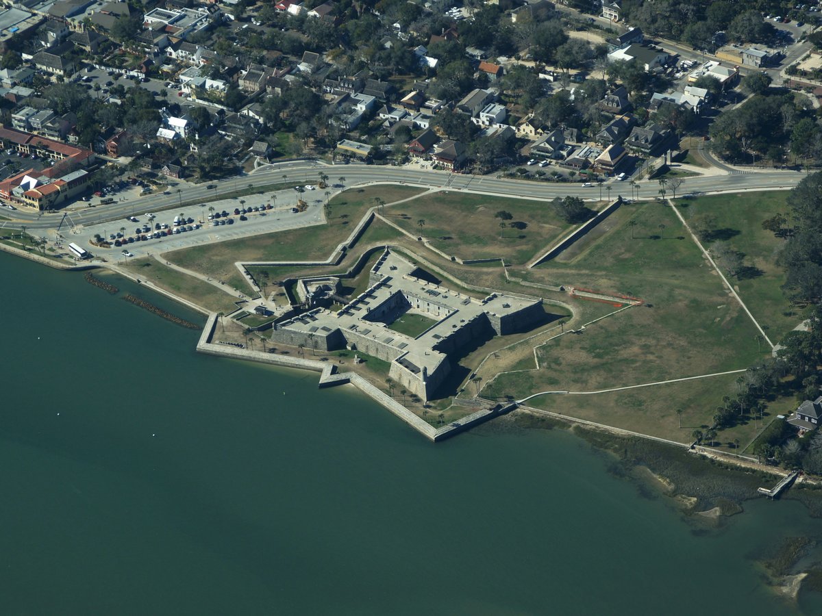 an aerial view of a fort on the water