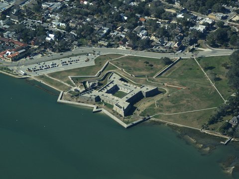 an aerial view of a fort on the water