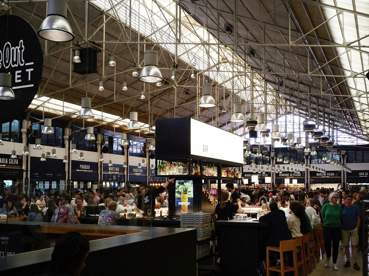 Time out market is bustling with people and activity.