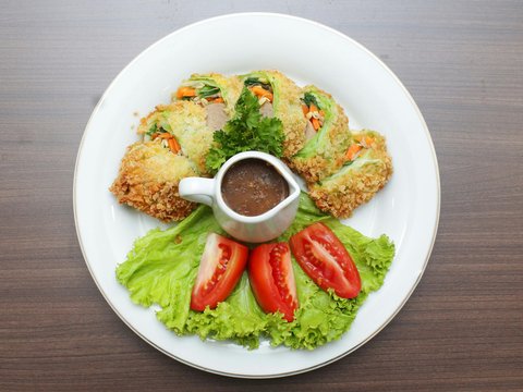 a white plate topped with food on top of a wooden table