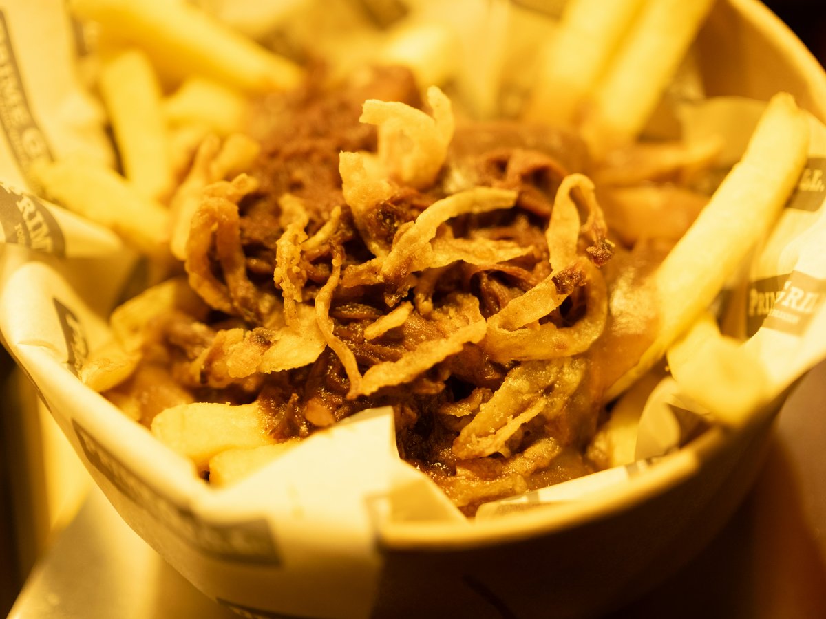 Basket of french fries with fried onions