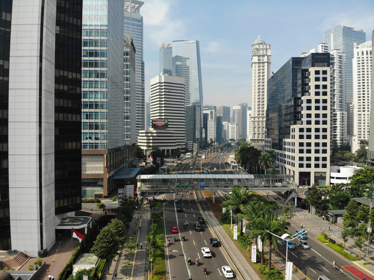 High-angle view of a multi-lane road with traffic and a pedestrian bridge in Jakarta