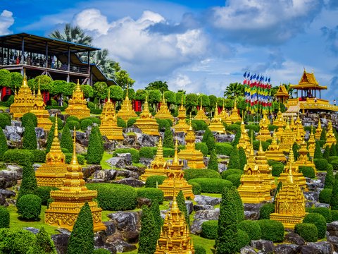 a large group of yellow statues in a garden