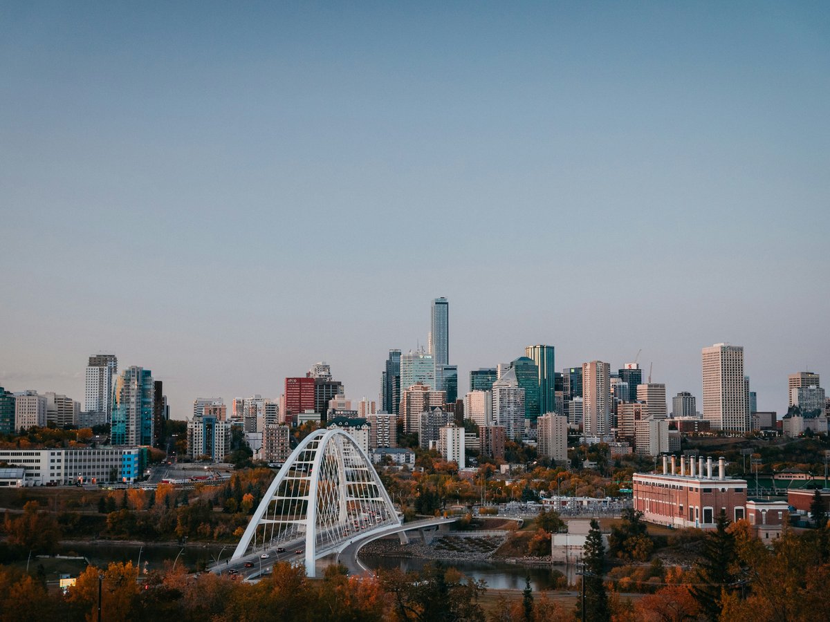 a city skyline with a bridge in the foreground