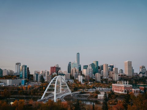 a city skyline with a bridge in the foreground